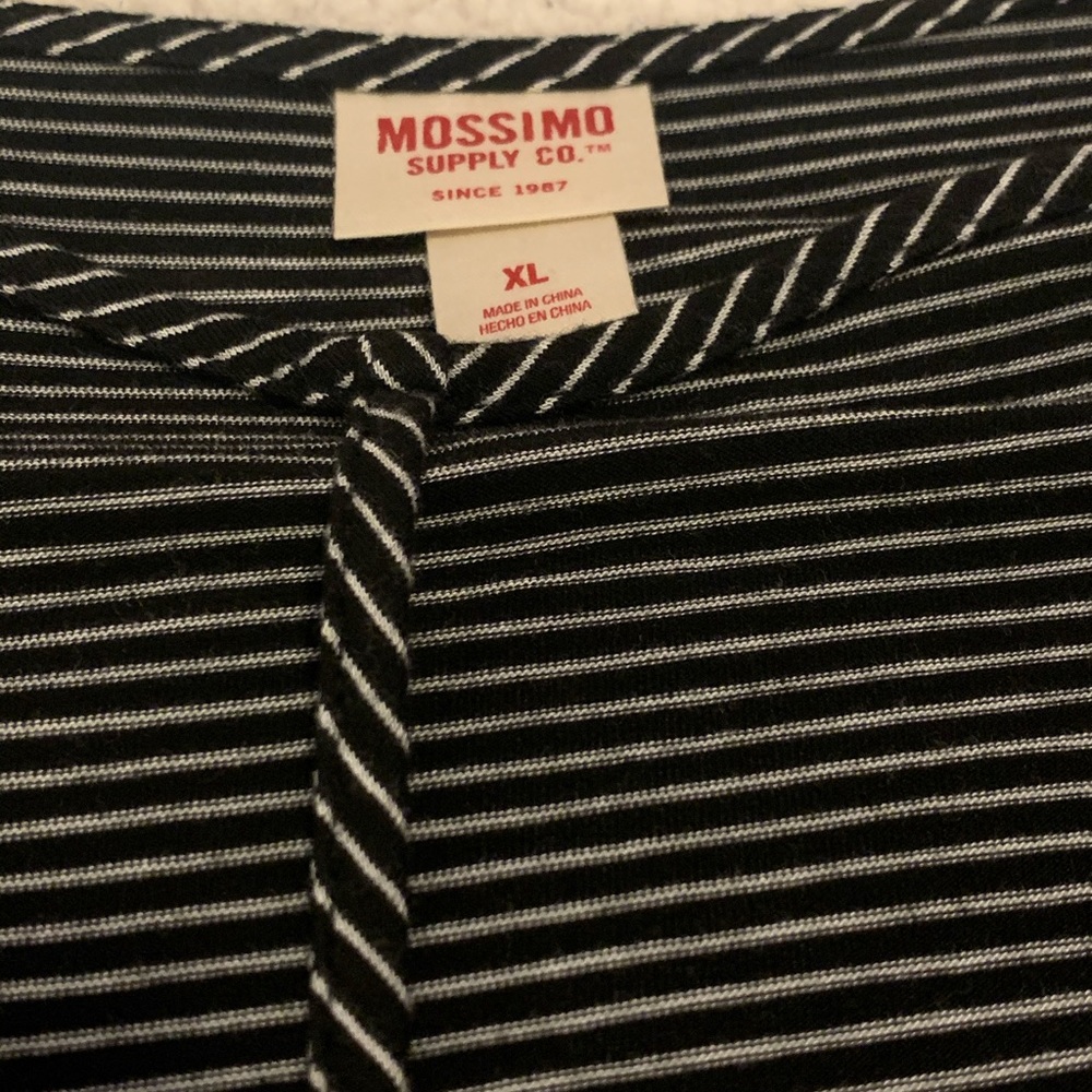 Black T-shirt-neck cross detail.